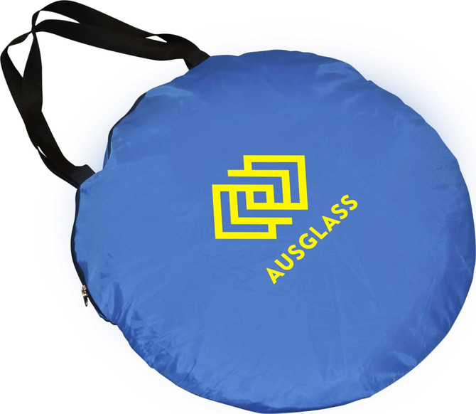 A blue pop-up beach shelter with a black strap and a logo on the surface.