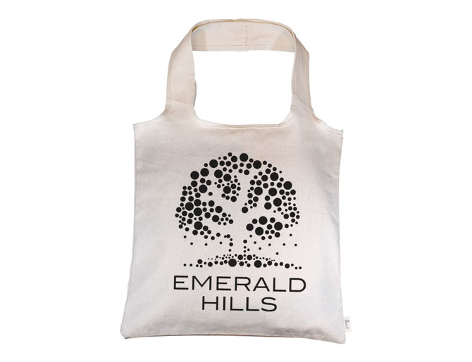 A natural-coloured tote bag with a tree design and branding, featuring shoulder straps for carrying.