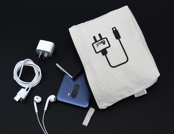 A cream-coloured tech pouch with an illustration, containing a phone, charger, earphones, and USB cable.