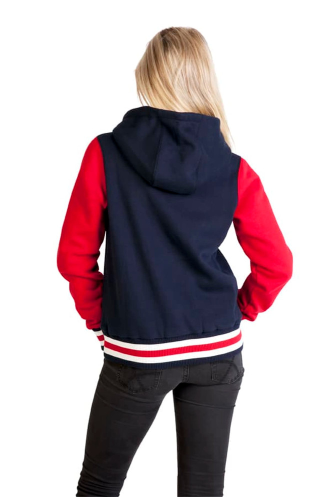 A women's varsity jacket with a navy body and red sleeves, featuring a hood and a striped hem.