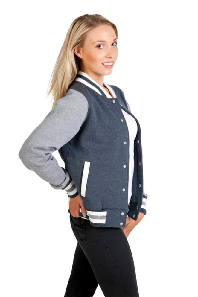 A women's junior varsity jacket in navy and grey, featuring white stripes and pockets, displayed on a model.