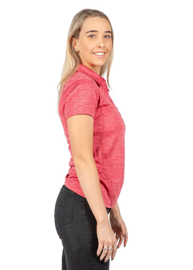 A woman wearing a pink, 100% polyester polo shirt, featuring a logo and set against a white background.