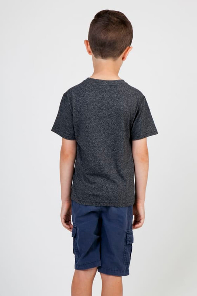 A boy wearing a dark grey heather T-shirt, standing with his back to the camera, paired with navy shorts.