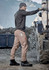 Men's curved cargo pants in beige, featuring multiple pockets, paired with dark boots and a grey beanie against a rugged backdrop.