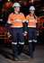 Two individuals in high-visibility orange shirts with reflective strips and navy cargo pants, wearing safety helmets and gloves.