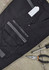A pair of black work pants featuring multiple pockets, a zipper, and a branding logo. Tools are placed beside them.