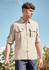 A long-sleeve, button-up shirt in beige, featuring two front pockets and a logo on the chest.