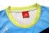 A blue AFL singlet with a light blue and lime green collar, featuring a logo and branding.