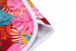 A vibrant beach shirt featuring a tropical floral pattern in pink, red, and green, with white trim.
