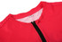 A bright pink cycling jersey featuring a zippered front and a mesh interior, with a logo on the collar.