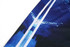 A close-up of a cricket jersey featuring blue tones with abstract patterns and a logo.
