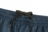 A close-up of dark navy shorts featuring an elastic waistband with a black drawstring. There is a logo on the waistband.