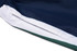 A close-up view of a navy blue sports uniform with white and green accents, featuring a logo on the side.