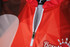 A red and grey bowling team shirt featuring a zip and a logo on the collar.