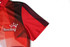A red and black bowling team jersey featuring geometric designs and a logo on the sleeve.