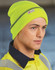 A bright neon yellow cuff beanie with a grey stripe, fitted snugly on a model's head. It features a brand logo tag.