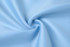 A light blue fabric swirled to display its smooth texture, ideal for clothing. It has a subtle sheen and appears soft.