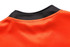 A close-up of the neckline of a rugby tee in vibrant orange with a black collar trim.