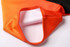 A rugby tee in orange and black, showcasing the collar and inner lining details. The item features a logo.