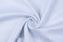 A light blue fabric swirled in a circular pattern, showcasing a smooth texture ideal for athletic wear.