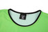 A green mesh staff bib with a black neckline and a tag indicating size M. It features a logo on the tag.