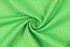 A bright green fabric with a textured pattern, showcasing a smooth, circular twist.