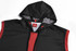 A sleeveless vest in black with red detailing and a hood, featuring a logo on the interior tag.
