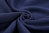 A close-up view of dark navy fleece fabric, showcasing its soft texture and smooth finish.