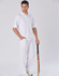 A model wearing white men's cricket pants, paired with a matching polo shirt, holding a cricket bat.