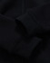 A black kid's full-zip fleecy hoodie featuring cuffed sleeves and a smooth texture. It has a logo on it.