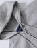 A grey full-zip fleecy hoodie featuring a hood and stitched detailing, with branding visible inside.