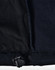 A close-up of a black ladies softshell jacket, highlighting the inner lining and adjustable hem detail.