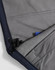 A close-up of a navy softshell hoodie featuring a grey fleece lining and a drawstring at the hem.