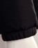 A black heavy quilted puffer jacket featuring a gathered cuff design, displayed on a mannequin.