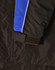 A close-up of a unisex jacket featuring black fabric with blue and white accents and a Velcro detail.