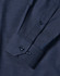 A men's long sleeve button-up shirt in navy with a pin dot pattern and cuff details. Features a logo.