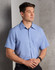 A short-sleeve men's shirt in light blue with a button-down front and a chest pocket, featuring a logo.