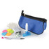 A blue cosmetic pouch contains a white lip balm, a dispenser, a pen, colorful sticky notes, and small white tablets.