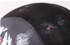 A black swimming cap featuring a smooth surface with a patterned design, including subtle colour accents.