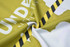A patterned fabric featuring yellow and black stripes, with an abstract design. It has a logo present.