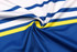 A close-up of interlock fabric featuring blue and white stripes with a yellow accent, showcasing its smooth texture.
