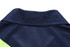 A close-up of the collar of a navy and lime green women's polo shirt featuring a logo.