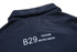 A dark blue polo shirt featuring a collar and printed detailing on the back, with a branding logo.
