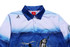 A blue and white fishing polo shirt with a graphic of a fish and a fishing scene, featuring a collar and branding.