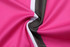 A close-up of a pink and black sublimated fabric, showcasing smooth texture and vibrant colours.