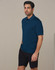 A man wearing a dark teal polo shirt and black cargo shorts, standing against a plain background.