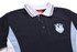 A black and light blue sublimated shirt with a collar and an embroidered emblem featuring a logo.