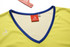 A yellow sports singlet with a blue neckline, featuring a logo and a tag indicating size M.