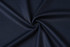 A close-up of dark navy textured fabric, showcasing a smooth, woven pattern with a slight sheen.