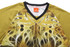 A sublimated T-shirt featuring vibrant yellow and brown designs, with a black V-neck collar and a logo on the label.